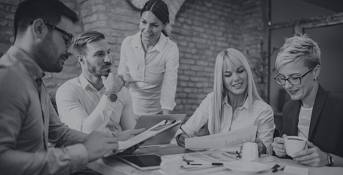 Office staff of Arrow marketing services discussing customer cases.