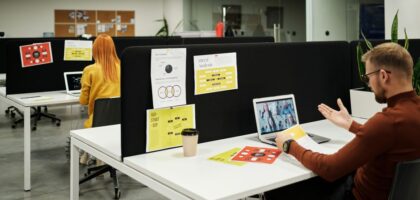 Colleagues working and collaborating virtually at a stylish modern office workspace.