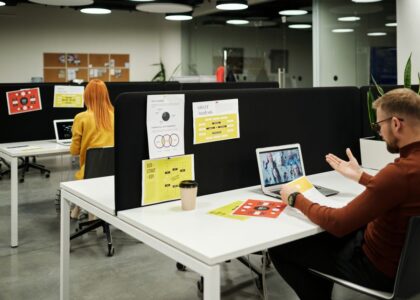 Colleagues working and collaborating virtually at a stylish modern office workspace.